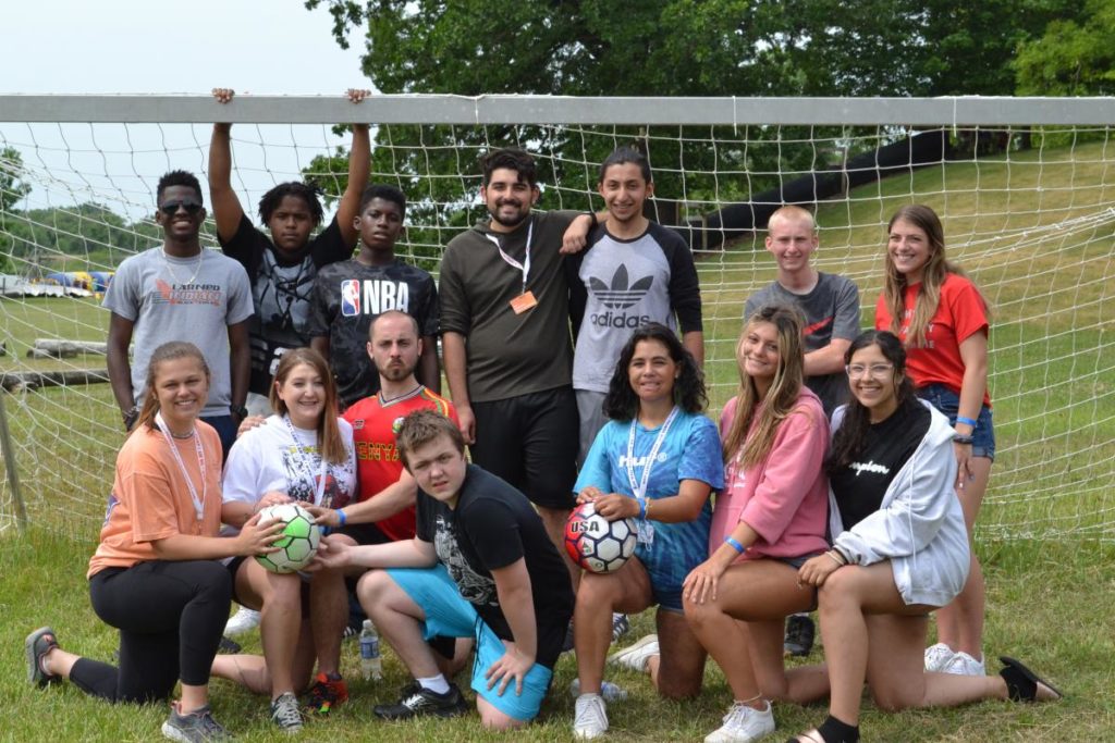 Camp I Am Me Campers posing with soccer ball in front of soccer net