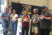 Smoke Alarm Installation Program Introduces New Corporate Partners - partners posting with alarms at Lowes