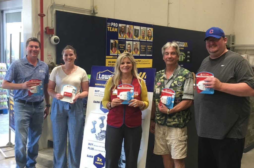Lowes Smoke Alarm program members holding smoke alarms