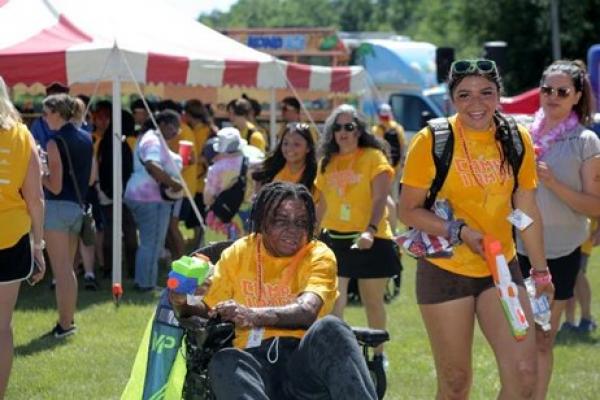 Participants of the Camp I Am Me fun fair playing with squirt guns