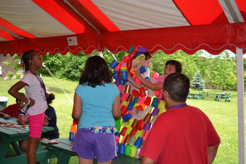 Campers playing a cup stacking game