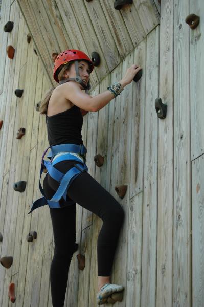 Camper practicing on a rock climbing wall