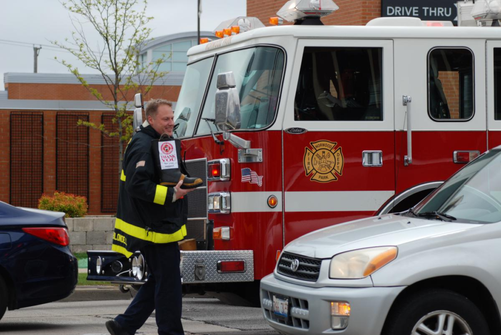 Firefighter on the street collecting funds with a boot